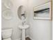 Stylish powder room with a pedestal sink, decorative mirror, and elegant wall accents at 5269 Luisa Ct, St Cloud, FL 34771