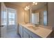 A bright bathroom with a double sink vanity, quartz countertop, and modern fixtures next to the window at 554 Highfalls Ave, Debary, FL 32713