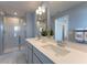 A well-lit bathroom with a shower, double sink vanity, quartz countertop, and modern fixtures and towels at 554 Highfalls Ave, Debary, FL 32713