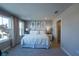 Bright and relaxing, beach-themed bedroom with large windows, soft carpet, and ensuite bathroom access at 554 Highfalls Ave, Debary, FL 32713