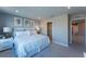 Comfortable beach-themed bedroom featuring a king bed, carpeted floors, ensuite bathroom, and walk-in closet at 554 Highfalls Ave, Debary, FL 32713