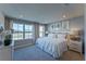 Bright, beach-themed main bedroom with a king bed, plush bedding and large windows with natural light at 554 Highfalls Ave, Debary, FL 32713
