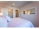 The bedroom has pink walls, carpet flooring, a walk-in closet, and a mirrored dresser at 554 Highfalls Ave, Debary, FL 32713