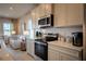 Modern kitchen with stainless steel appliances, white cabinetry, and stylish backsplash at 554 Highfalls Ave, Debary, FL 32713