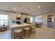 Well-lit kitchen with a center island, stainless steel appliances, and a dining area at 554 Highfalls Ave, Debary, FL 32713