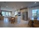 Open-concept kitchen featuring a center island, stainless steel appliances, and seamless integration with dining and living areas at 554 Highfalls Ave, Debary, FL 32713