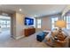 A living room with a large TV, ample windows for light, and a comfortable seating area with stylish decor at 554 Highfalls Ave, Debary, FL 32713