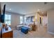 Comfortable living room features a cozy sectional sofa and bright natural light from large windows at 554 Highfalls Ave, Debary, FL 32713