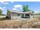 Rear view of home's siding and patio area featuring a sliding glass door and freshly painted siding at 2404 Needle Palm Dr, Edgewater, FL 32141