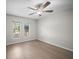 Well-lit bedroom with a ceiling fan, two windows, and laminate flooring creating a cozy atmosphere at 2404 Needle Palm Dr, Edgewater, FL 32141