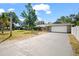 Spacious driveway leads to a two-car garage with attractive stone detail at 2404 Needle Palm Dr, Edgewater, FL 32141