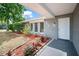 Charming front porch with manicured landscaping and a freshly painted front door at 2404 Needle Palm Dr, Edgewater, FL 32141