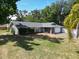 Ranch-style home with stone accents, mature landscaping, and a well-maintained lawn at 2404 Needle Palm Dr, Edgewater, FL 32141