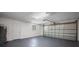 Spacious two-car garage with painted floor, access door, window, and ample lighting at 2404 Needle Palm Dr, Edgewater, FL 32141