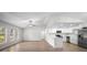 Open-concept living room featuring hardwood flooring, a modern kitchen, and plenty of natural light at 2404 Needle Palm Dr, Edgewater, FL 32141