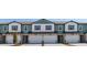 Townhome showcases neat landscaping, attached garages, neutral tones, and a welcoming entryway at 1130 Desert Candle Dr, Ocoee, FL 34761