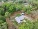 Aerial view of property showcasing the home, new shed, surrounding trees, and overall lot layout at 1161 Cr 443, Lake Panasoffkee, FL 33538