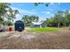 View of backyard showcasing new shed and work area in a well-maintained lot at 1161 Cr 443, Lake Panasoffkee, FL 33538