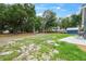 Large backyard featuring a storage shed, open space, and a peaceful, partially shaded area at 1161 Cr 443, Lake Panasoffkee, FL 33538