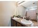 Bathroom featuring double vanity with a large mirror and shower with patterned curtain at 1161 Cr 443, Lake Panasoffkee, FL 33538