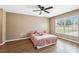 Cozy bedroom features laminate flooring, a ceiling fan and a window that provides natural light at 1161 Cr 443, Lake Panasoffkee, FL 33538