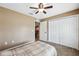 Bedroom featuring neutral walls, carpet, ceiling fan, and closet for ample storage space at 1161 Cr 443, Lake Panasoffkee, FL 33538