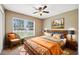 Comfortable bedroom with wooden bed frame, ceiling fan, and a window offering natural light at 1161 Cr 443, Lake Panasoffkee, FL 33538
