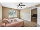 Comfortable bedroom with laminate flooring, ceiling fan and natural light from a window at 1161 Cr 443, Lake Panasoffkee, FL 33538