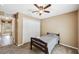 Bedroom features carpet flooring, ceiling fan, closet for storage space, and a doorway to the hallway at 1161 Cr 443, Lake Panasoffkee, FL 33538
