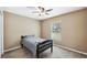 Cozy bedroom with carpet flooring, ceiling fan, and a bright window offering plenty of natural light at 1161 Cr 443, Lake Panasoffkee, FL 33538