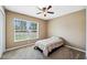 Cozy bedroom with carpet flooring, ceiling fan, and a bright window with natural light at 1161 Cr 443, Lake Panasoffkee, FL 33538