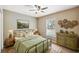 Bedroom with a metal bed frame, floral accents, and natural light provided by the large window at 1161 Cr 443, Lake Panasoffkee, FL 33538