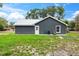 Exterior of home with neutral paint, green grass, simple seating area with easy access to entry at 1161 Cr 443, Lake Panasoffkee, FL 33538