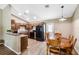 Well-lit kitchen and dining area with wood cabinets, black appliances, and a table for six, perfect for Gathering meals at 1161 Cr 443, Lake Panasoffkee, FL 33538