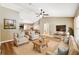 Cozy living room with hardwood floors, neutral paint, comfortable seating, and an open layout leading into the kitchen at 1161 Cr 443, Lake Panasoffkee, FL 33538