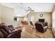 Open-concept living room with wood floors, vaulted ceiling, comfortable seating and seamlessly connects to the dining area at 1161 Cr 443, Lake Panasoffkee, FL 33538