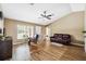 Bright living room with vaulted ceilings, wood floors, comfortable seating, and a view of the dining area at 1161 Cr 443, Lake Panasoffkee, FL 33538