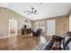 Spacious living room featuring vaulted ceiling, wood floors, a comfortable seating area, and lots of natural light at 1161 Cr 443, Lake Panasoffkee, FL 33538