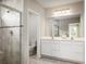 Elegant bathroom with a glass-enclosed shower, double vanity, and neutral tile flooring at 1548 Covey Rise Ter, Winter Haven, FL 33884