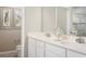 Elegant bathroom with double sinks, white cabinets, and a glass-enclosed shower at 1548 Covey Rise Ter, Winter Haven, FL 33884