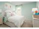 Bright bedroom with floral accents, light-colored walls, and plush carpeting creates a relaxing atmosphere at 1548 Covey Rise Ter, Winter Haven, FL 33884