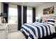 Nautical-themed bedroom featuring bright windows, striped bedding, and vibrant decor at 1548 Covey Rise Ter, Winter Haven, FL 33884