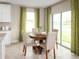 Cozy dining area with a round table, four chairs, and large sliding glass doors, offering bright light and inviting space at 1548 Covey Rise Ter, Winter Haven, FL 33884