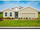 Charming single-story home with a well-manicured lawn and colorful landscaping, complete with an attached two-car garage at 1548 Covey Rise Ter, Winter Haven, FL 33884