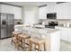 Modern kitchen featuring granite countertops, stainless steel appliances, white cabinets, and a central island with seating at 1548 Covey Rise Ter, Winter Haven, FL 33884