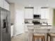 Beautiful open concept kitchen with stainless steel appliances, granite countertops, island with breakfast bar, and white cabinetry at 1548 Covey Rise Ter, Winter Haven, FL 33884