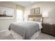 Comfortable bedroom with a decorative headboard, matching nightstands, and natural light at 1548 Covey Rise Ter, Winter Haven, FL 33884
