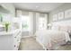 Bright bedroom with soft colors, large windows, and a white dresser with a decorative mirror at 2193 Aibonito Cir, Clermont, FL 34711