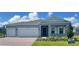 Charming single-story home with a brick driveway, manicured lawn, and a two-car garage at 2193 Aibonito Cir, Clermont, FL 34711