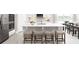 A bright kitchen with stainless steel appliances, an island with seating, and an adjacent dining table at 2193 Aibonito Cir, Clermont, FL 34711